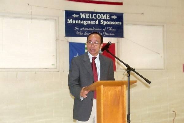 Rong at podium with flag